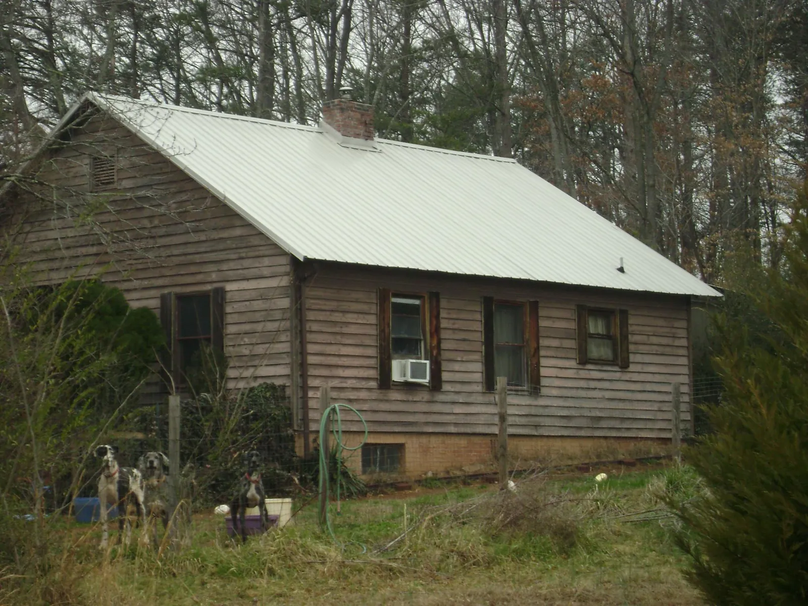 White metal roof on an old wood sided farmhouse, from a Metal Roof Installation job in Fostoria
